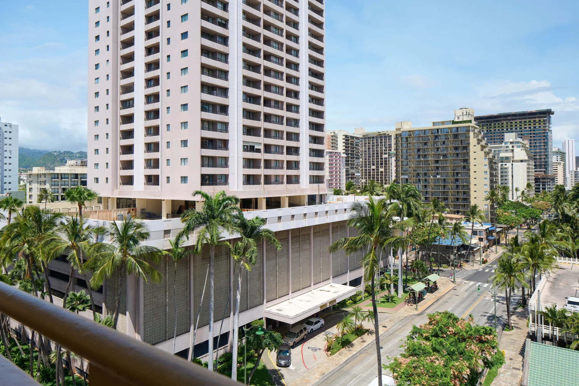 Daytime city view with high-rises and palm-lined streets from Waikiki Malia.