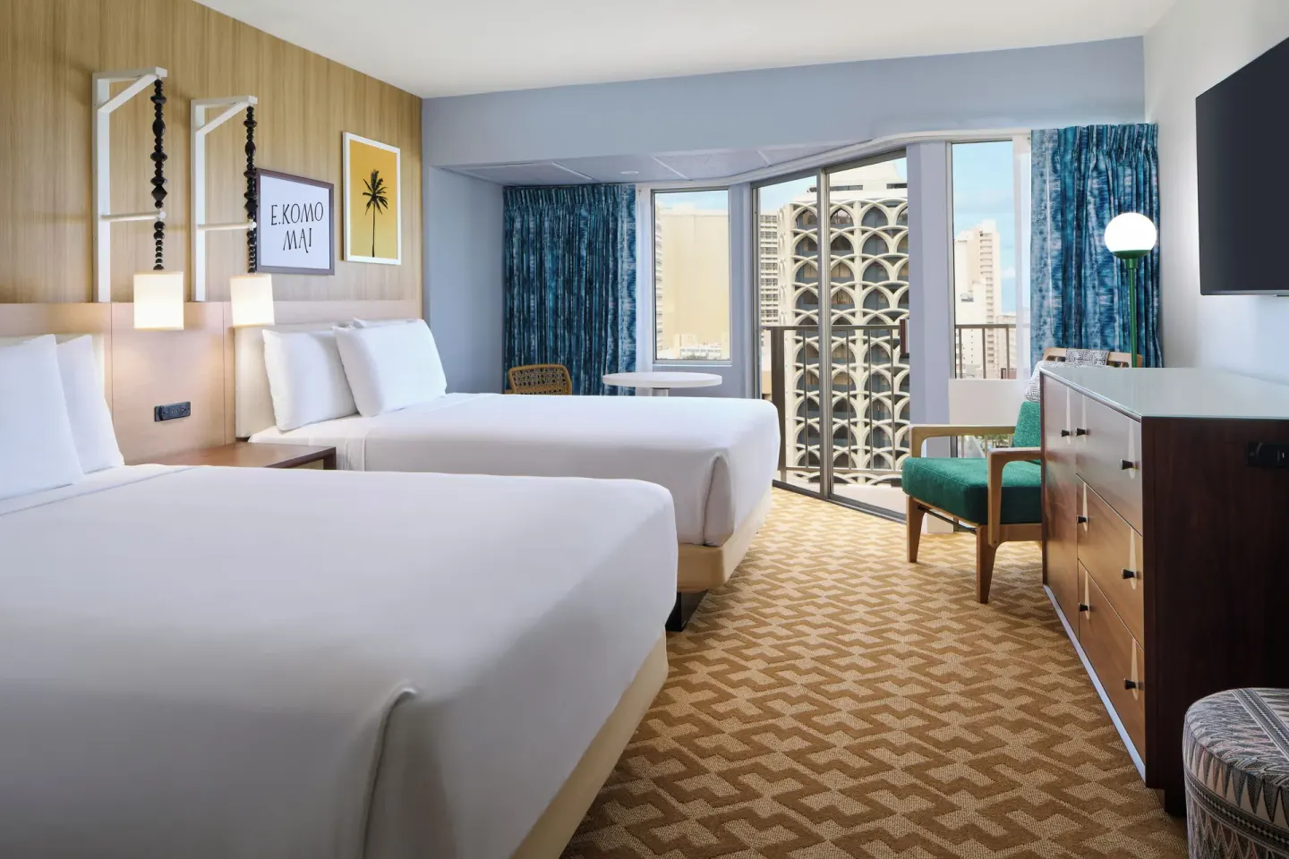 Two-bed Partial Ocean View room with dresser and balcony doors at Waikiki Malia.
