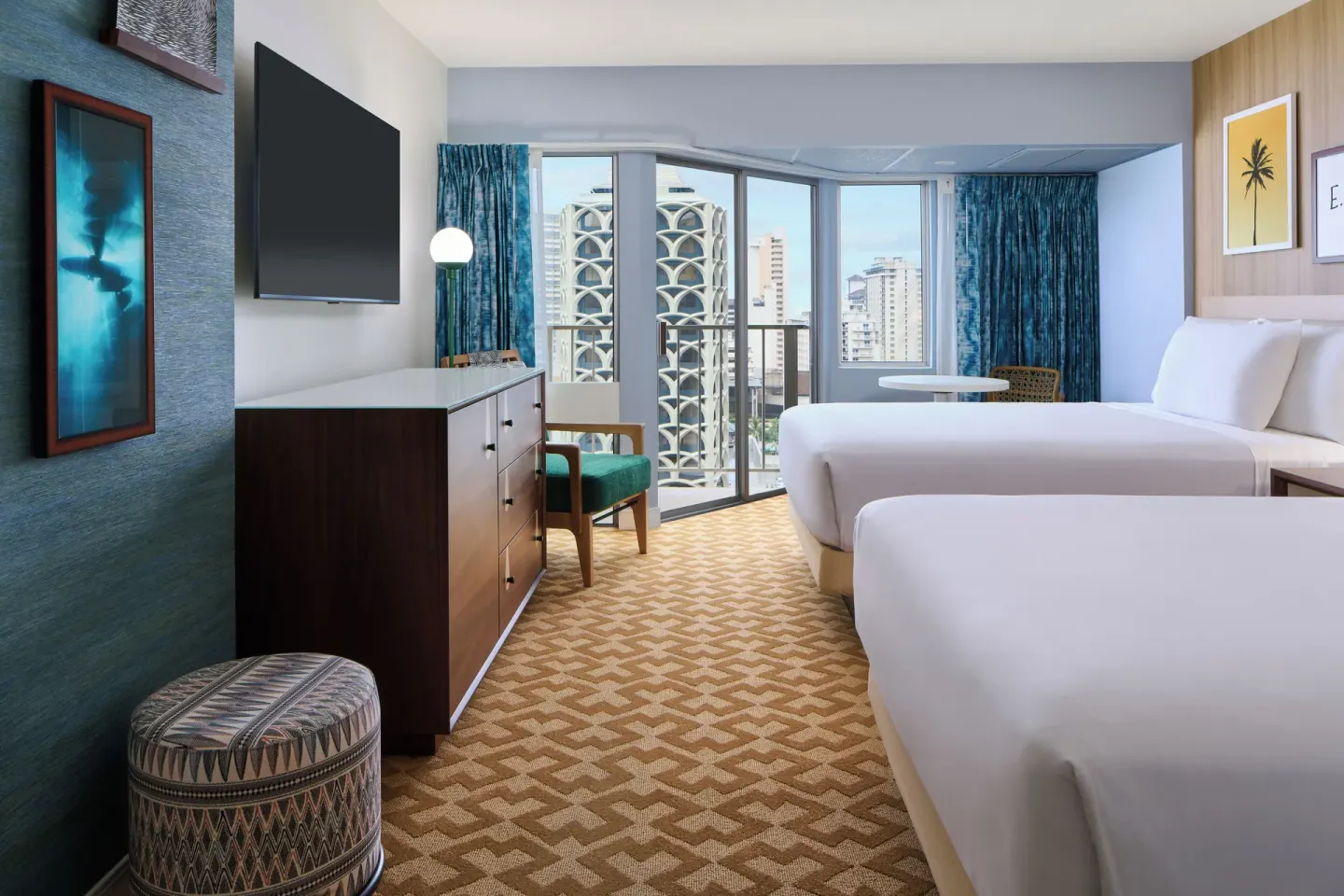 Partial Ocean View room with two beds, TV, dresser, and corner windows at Waikiki Malia.
