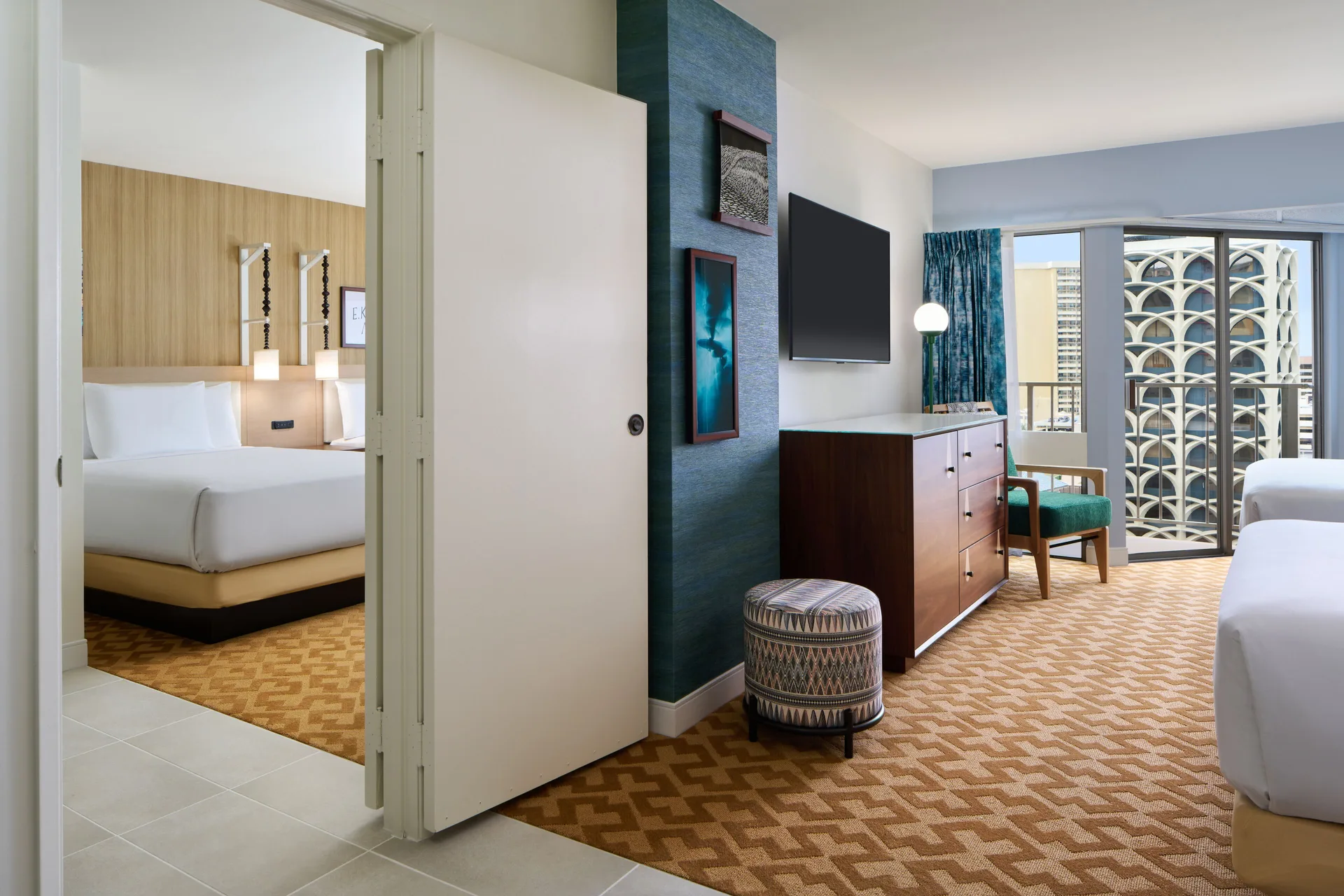 Partial Ocean View room with two beds, dresser, TV, and balcony at Waikiki Malia.