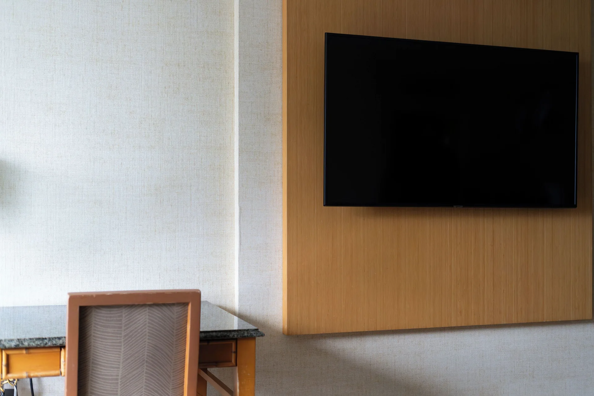 Wall-mounted television beside a desk area in a guest room at Waikiki Resort Hotel.