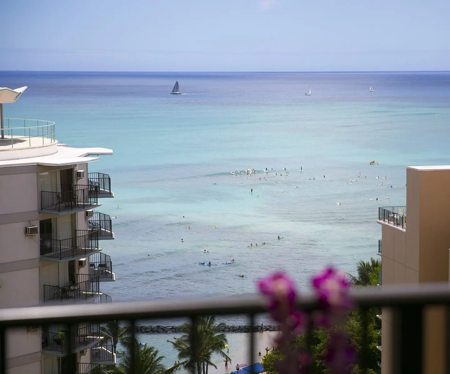 Ocean view with sailboats and swimmers from Waikiki Resort Hotel.