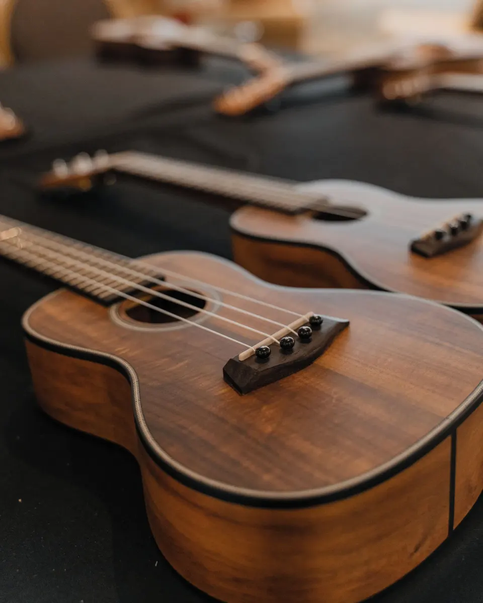 Close-up of ukuleles arranged on a dark surface at Waikiki Resort Hotel.