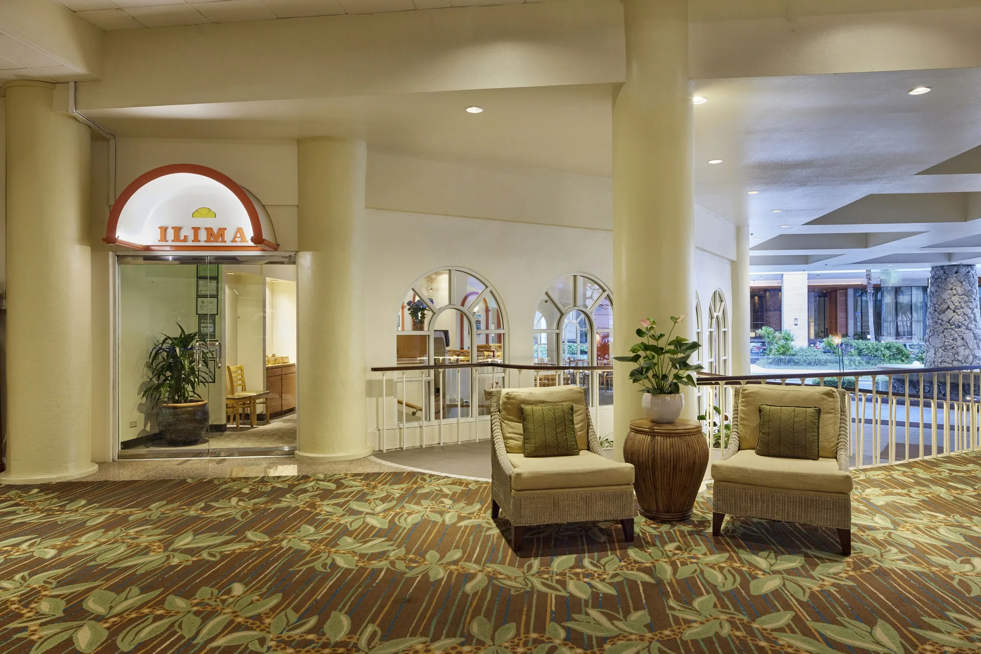 The Ilima Café entrance and nearby lounge seating are shown at Waikiki Resort Hotel.