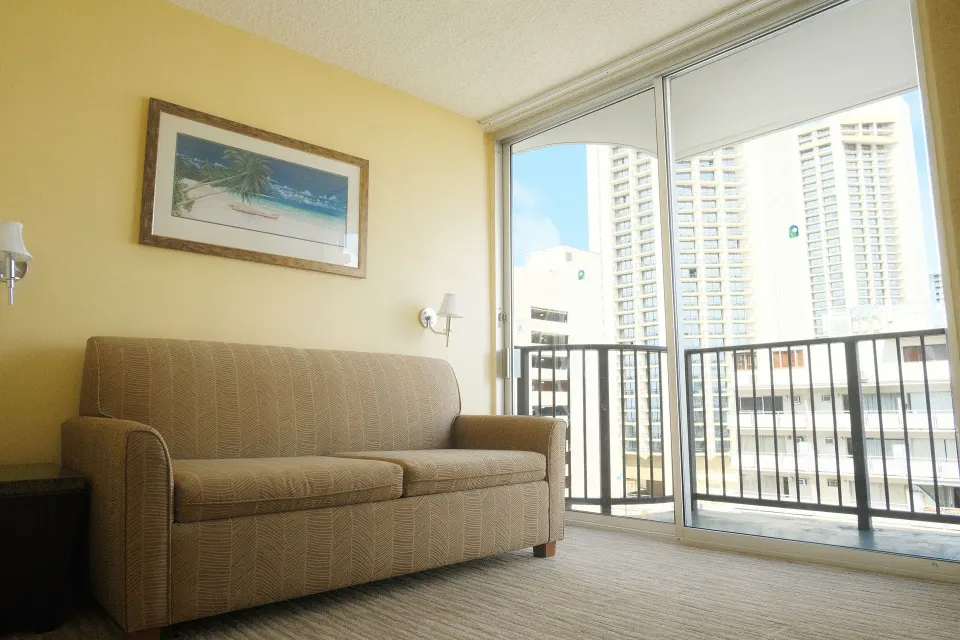 Suite Mountain View sofa by balcony windows at Waikiki Resort Hotel.