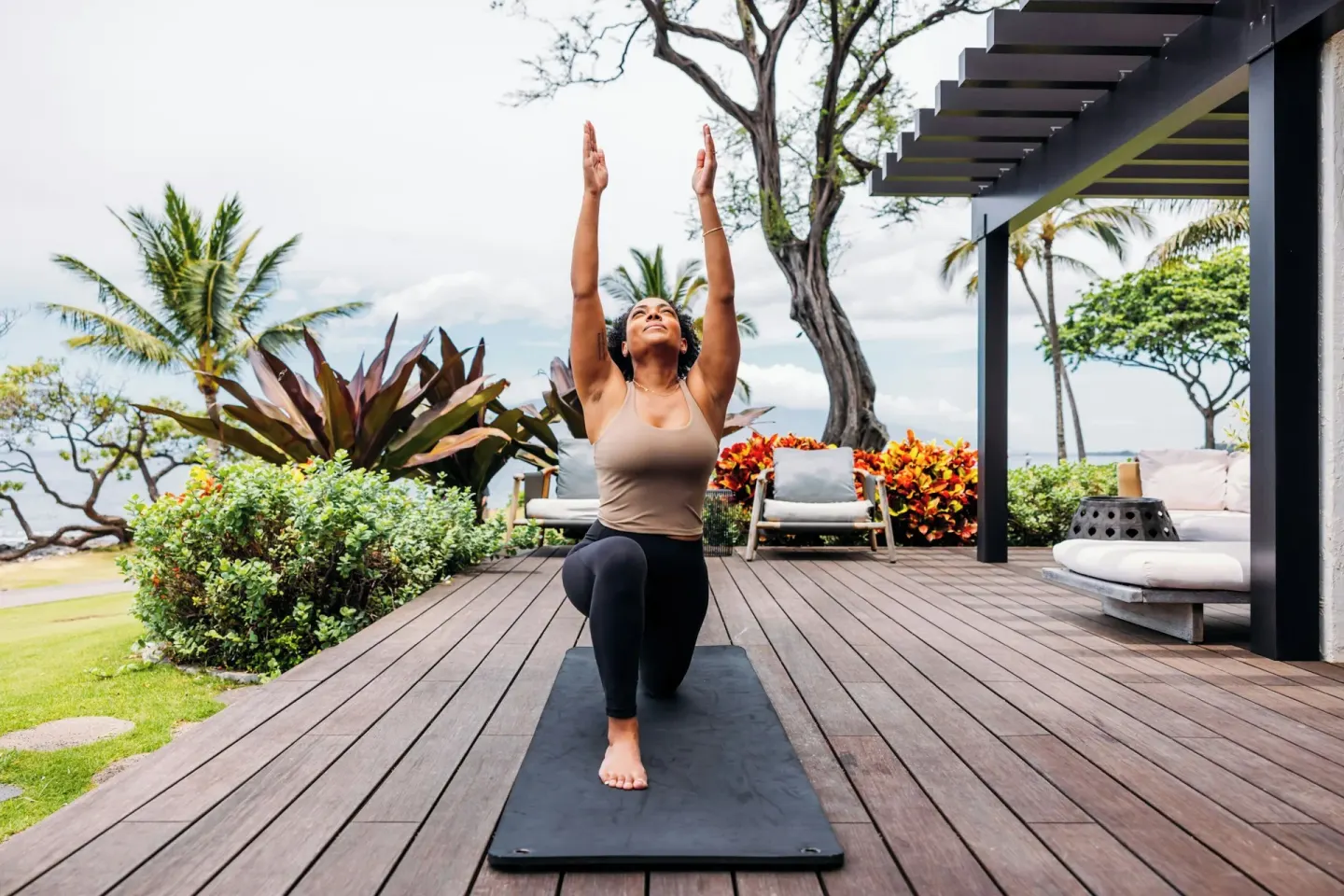 Guest practices yoga on a garden terrace at Wailea Beach Resort - Marriott, Maui.