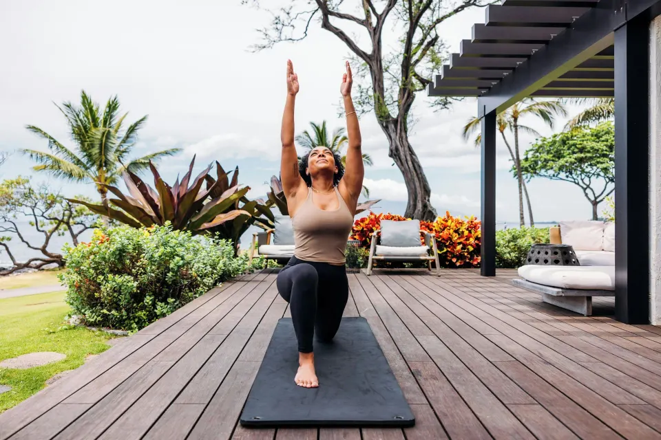 Guest practices yoga on a garden terrace at Wailea Beach Resort - Marriott, Maui.