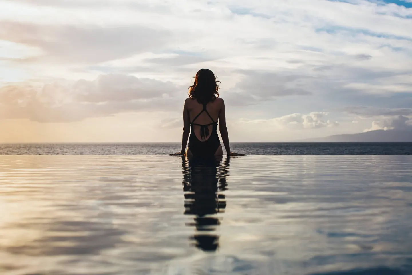 Guest sitting at an infinity pool edge at Wailea Beach Resort - Marriott, Maui.