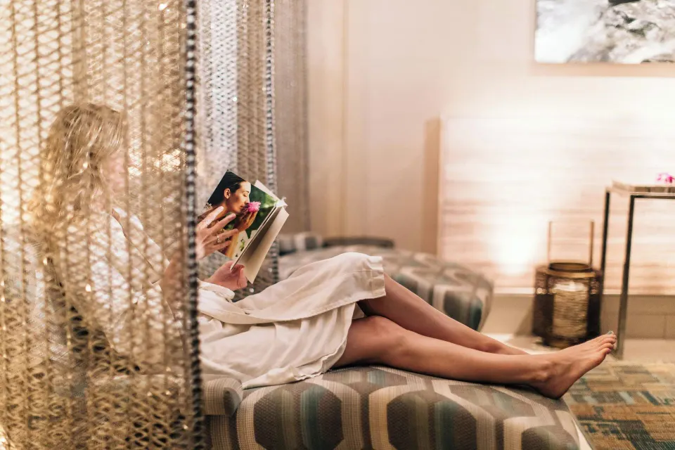 Spa relaxation lounge with a guest reading at Wailea Beach Resort - Marriott, Maui.