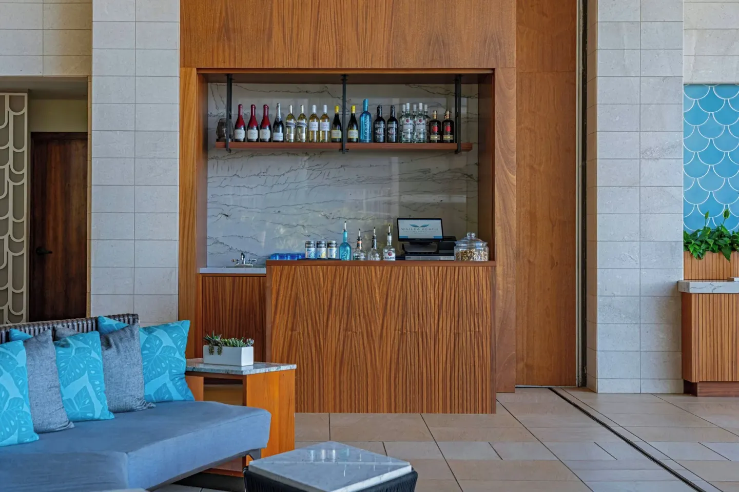 Wood-paneled lobby bar with blue seating at Wailea Beach Resort - Marriott, Maui.