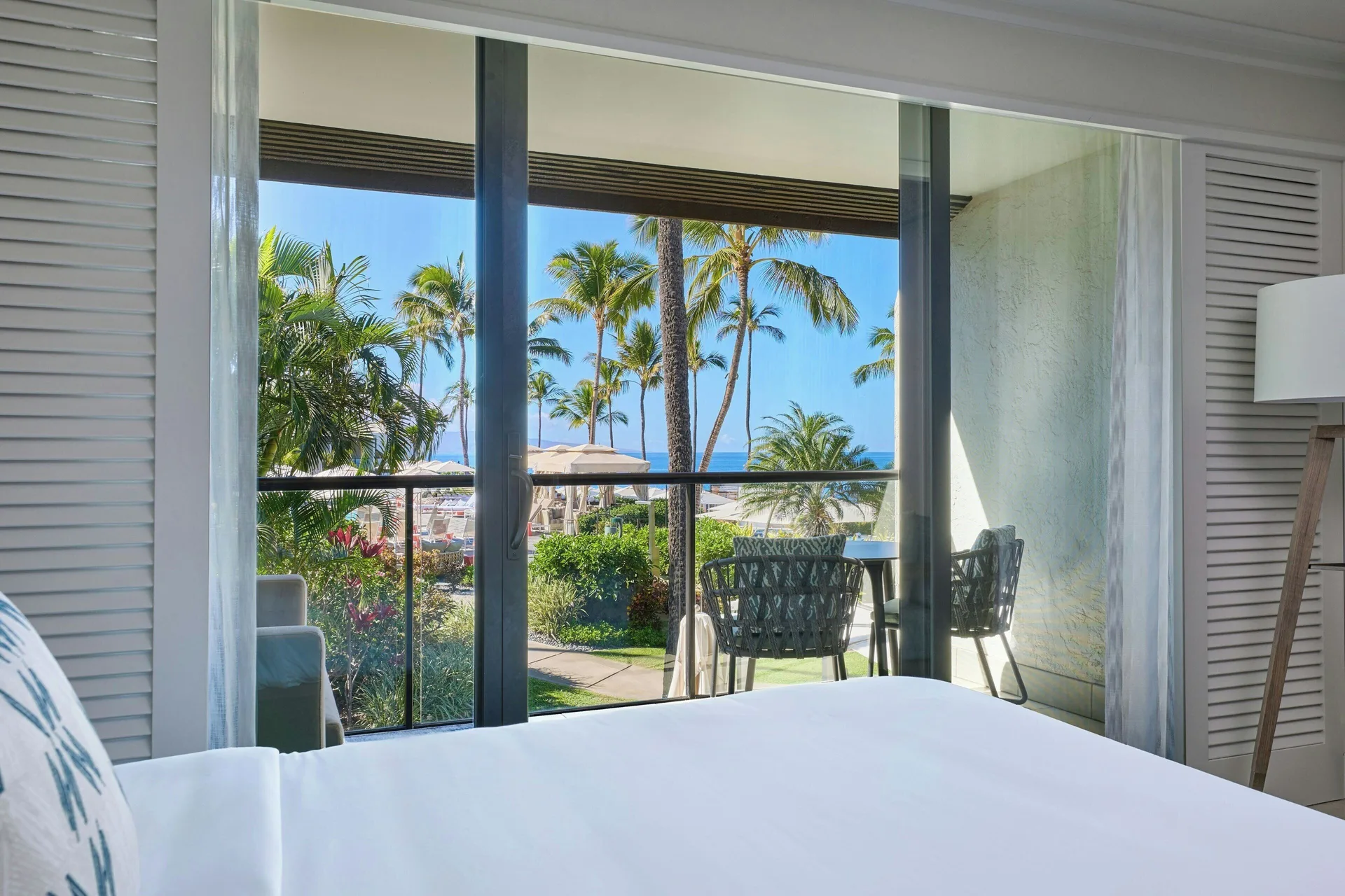 Oceanfront junior suite bed and patio view at Wailea Beach Resort - Marriott, Maui.