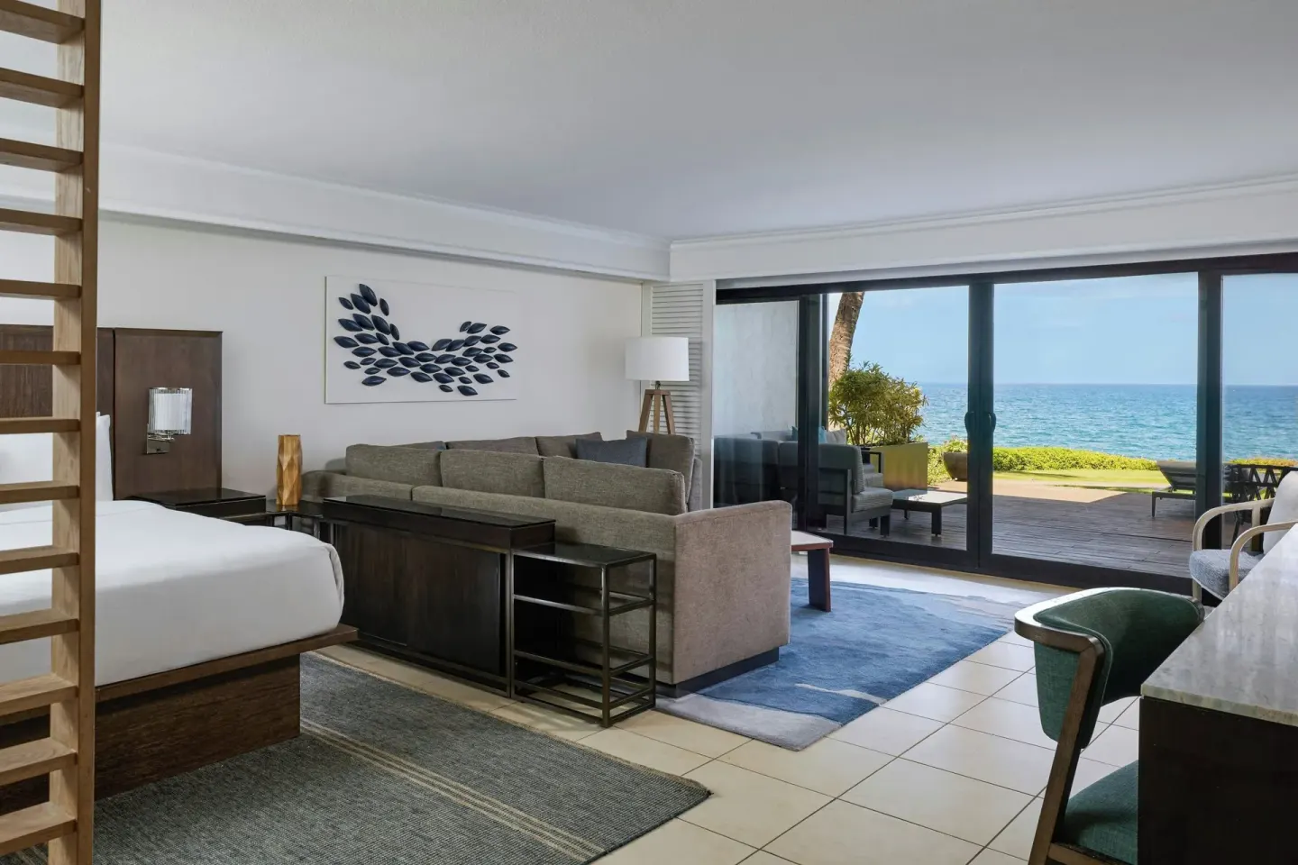 Oceanfront junior suite with king bed, sofa, and terrace at Wailea Beach Resort - Marriott, Maui.