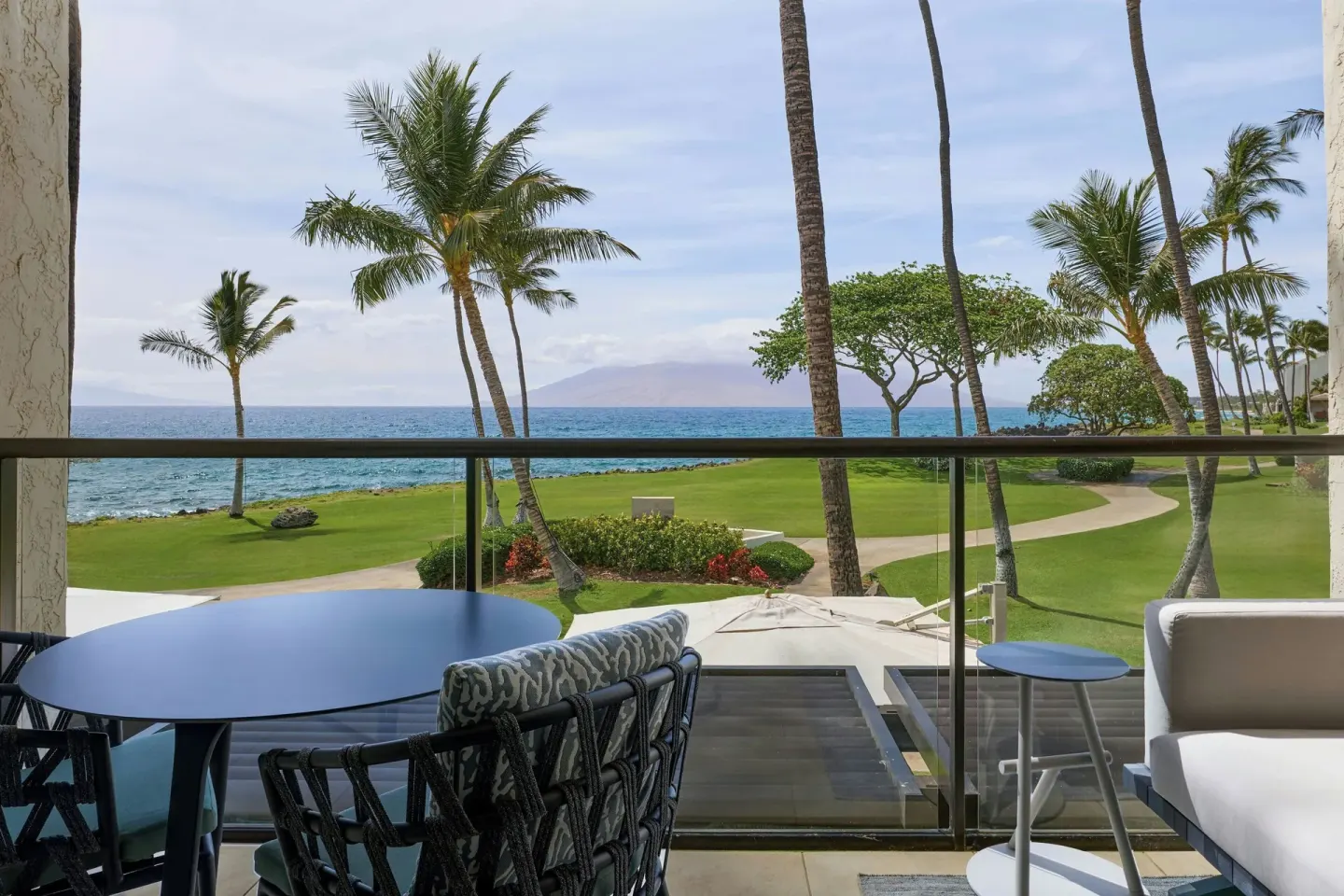 Furnished ocean-view balcony at Wailea Beach Resort - Marriott, Maui overlooking palms and lawn.