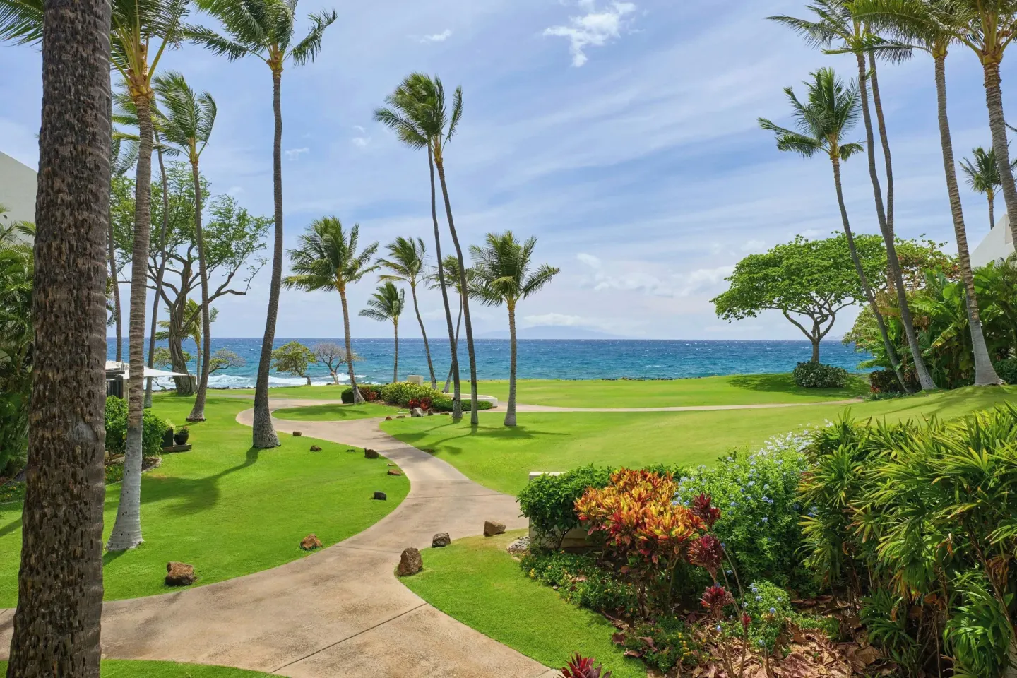Tropical grounds and ocean view at Wailea Beach Resort - Marriott, Maui with palms and walkways.