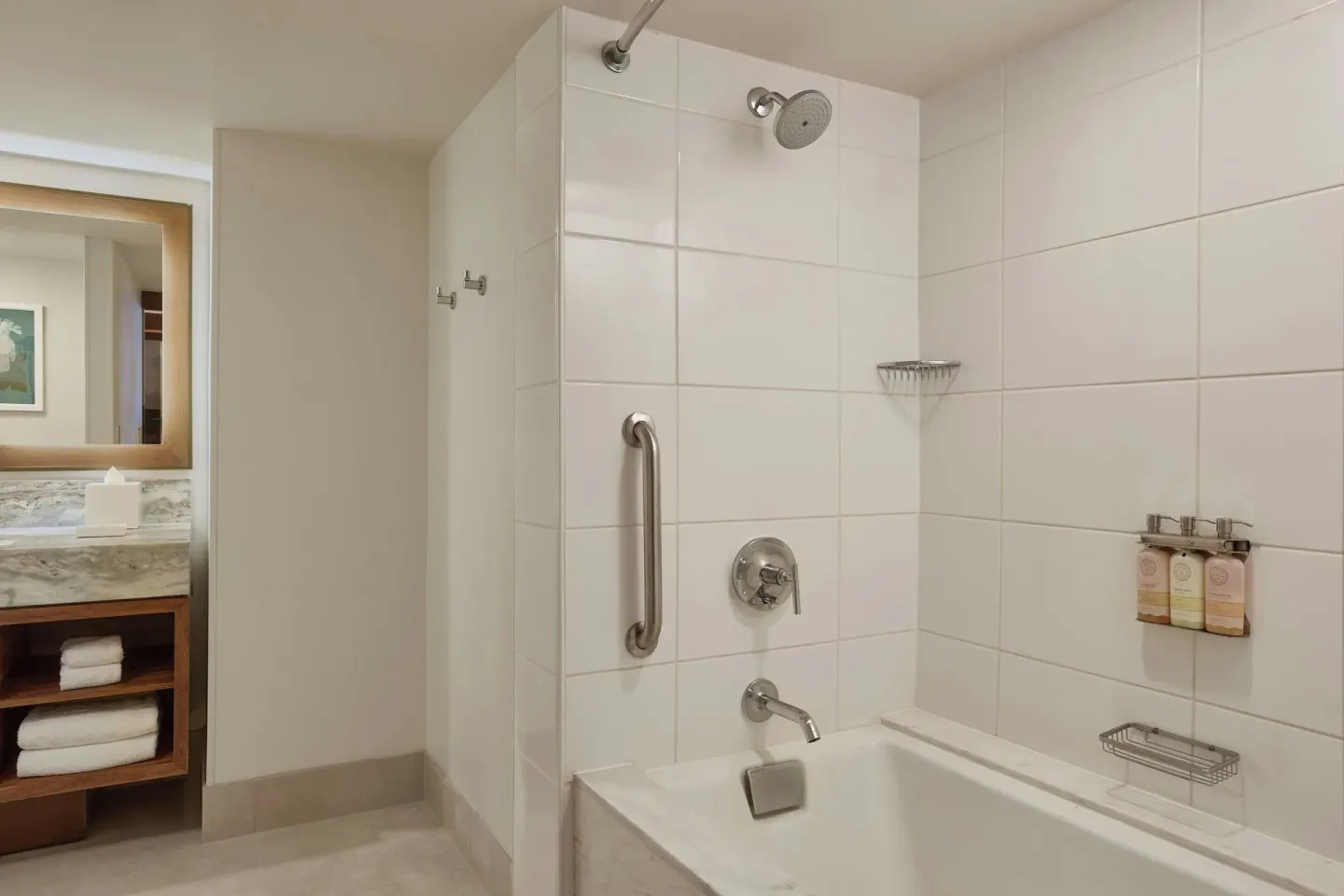 Tiled bathtub and shower in a premium two-bedroom suite bathroom at Wailea Beach Resort - Marriott, Maui.
