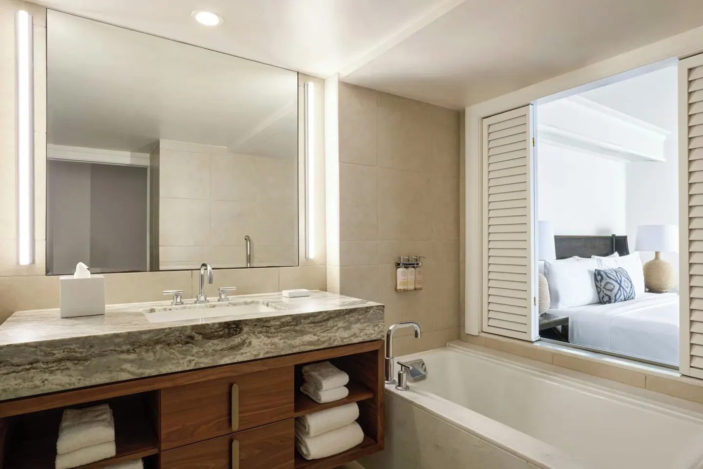 Bathroom vanity and soaking tub beside a bedroom in a premium suite at Wailea Beach Resort - Marriott, Maui.