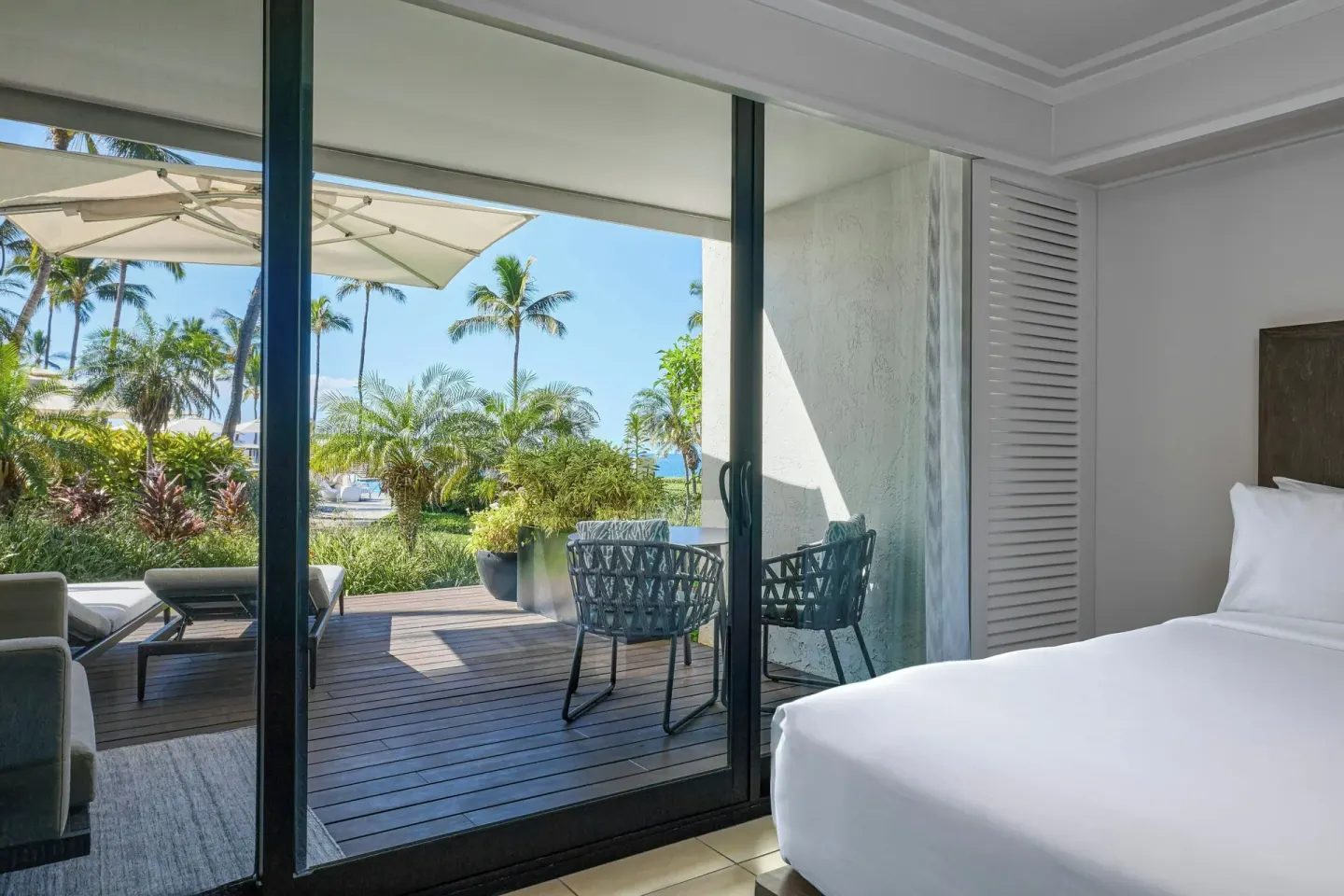 King bed beside sliding doors to an ocean-view lanai at Wailea Beach Resort - Marriott, Maui.