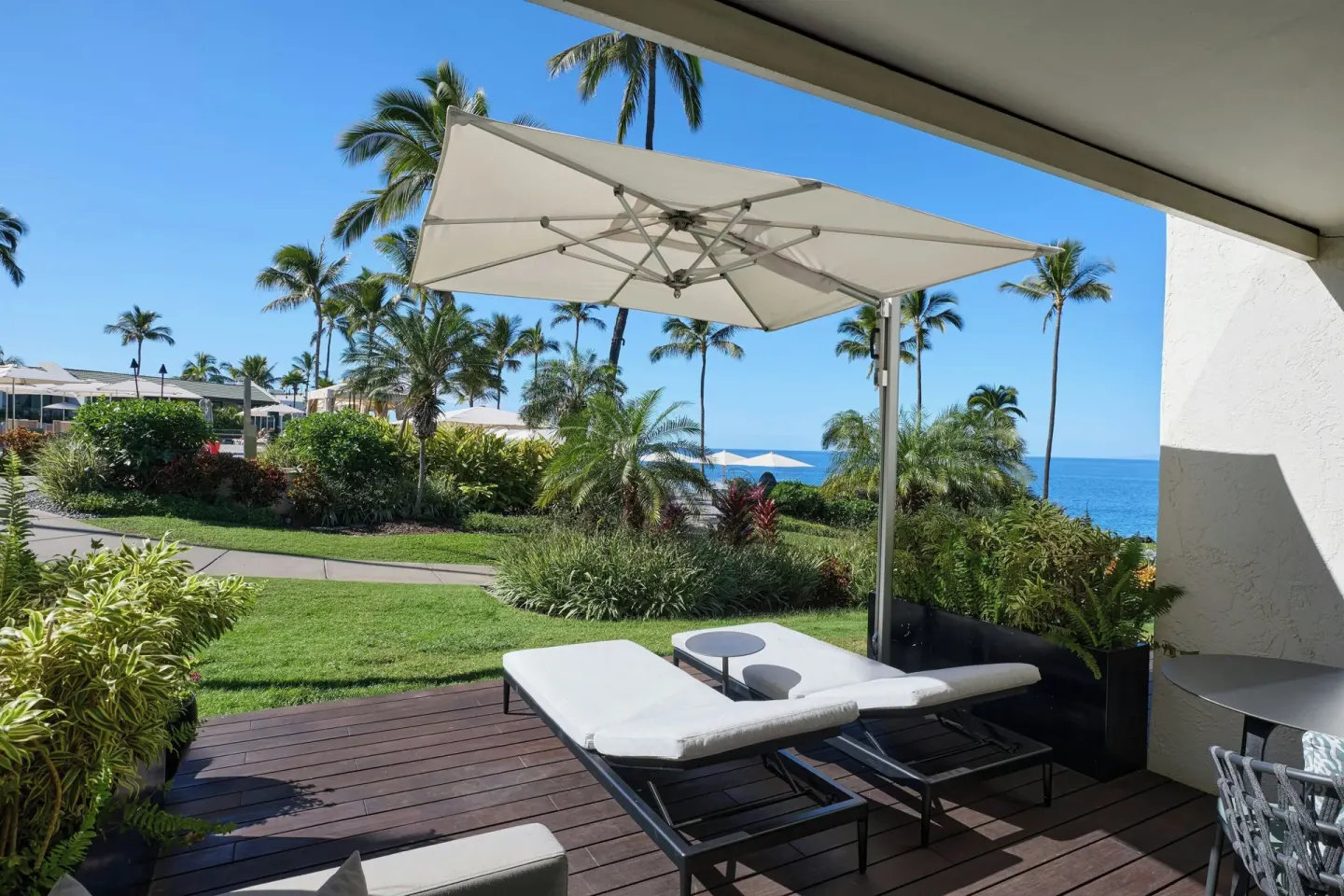 Sundeck loungers under an umbrella outside a room at Wailea Beach Resort - Marriott, Maui.