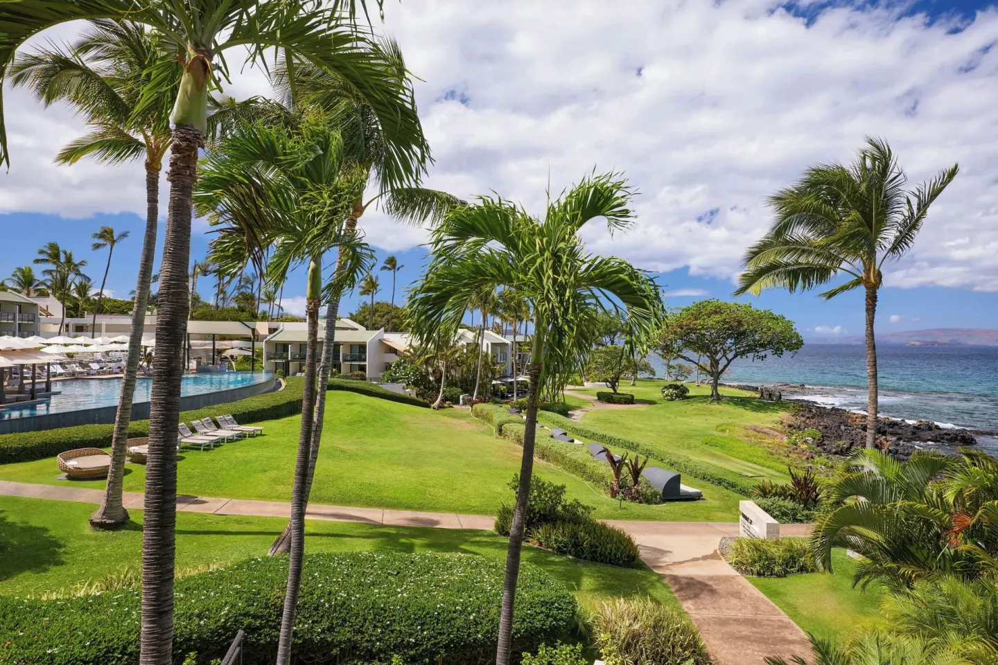 Oceanfront lawn, palms and pool area seen from the room at Wailea Beach Resort - Marriott, Maui.
