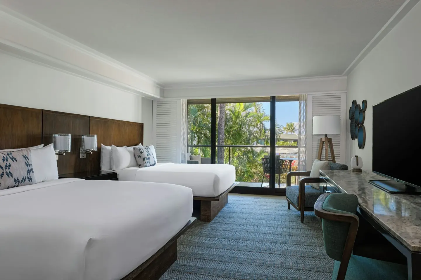 Two queen beds and balcony doors in a partial ocean view room at Wailea Beach Resort - Marriott, Maui.