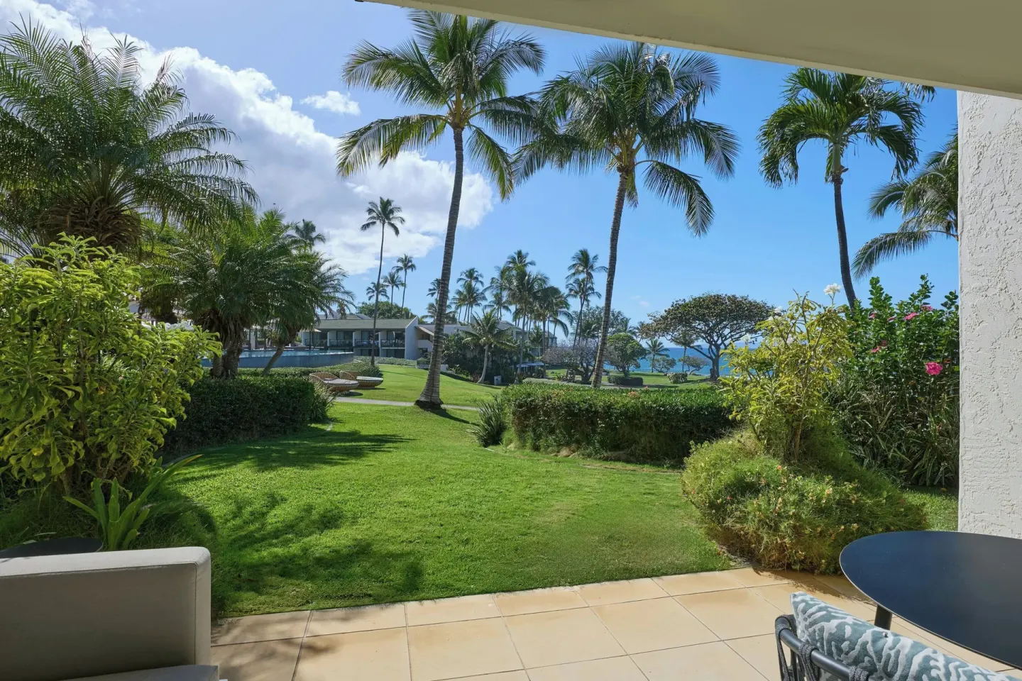 Covered balcony with seating and a partial ocean view at Wailea Beach Resort - Marriott, Maui.