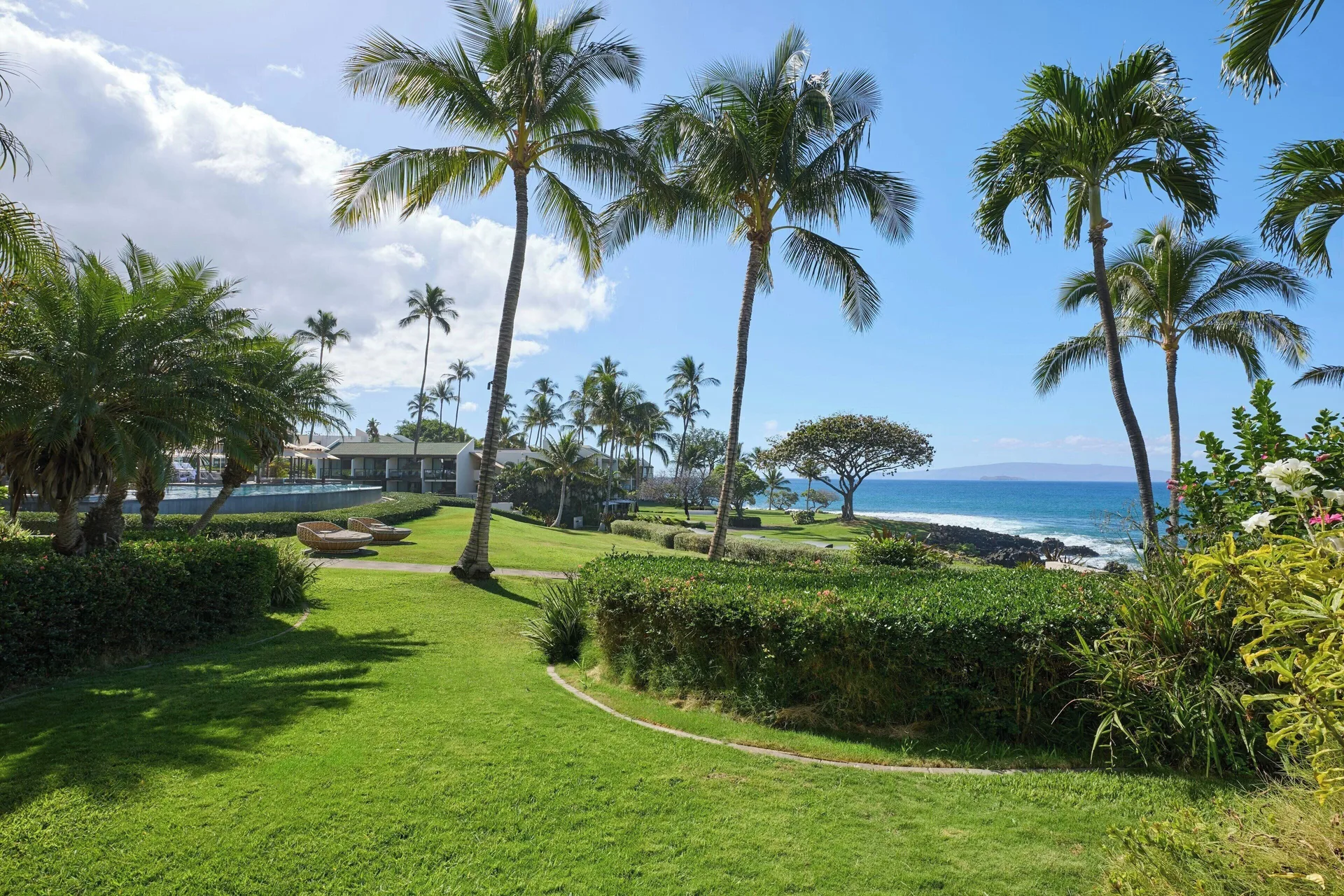 Room with Sofa Bed Partial Ocean View Balcony at Wailea Beach Resort - Marriott, Maui with partial Pacific Ocean views, tropical landscaping, and balcony seating.