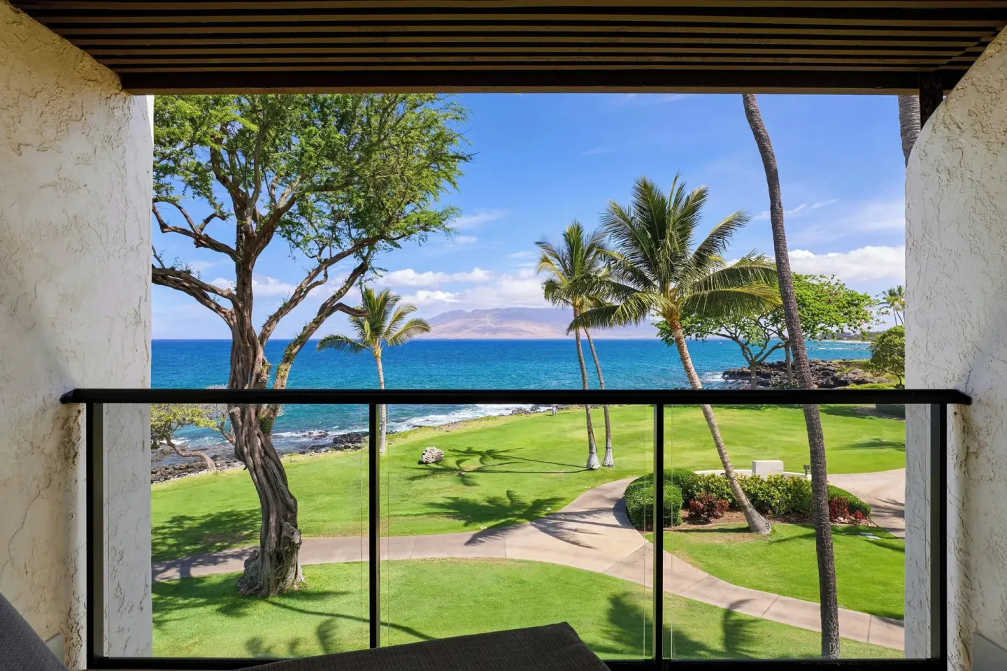 Oceanfront suite balcony view at Wailea Beach Resort - Marriott, Maui with palms, lawn and blue water.