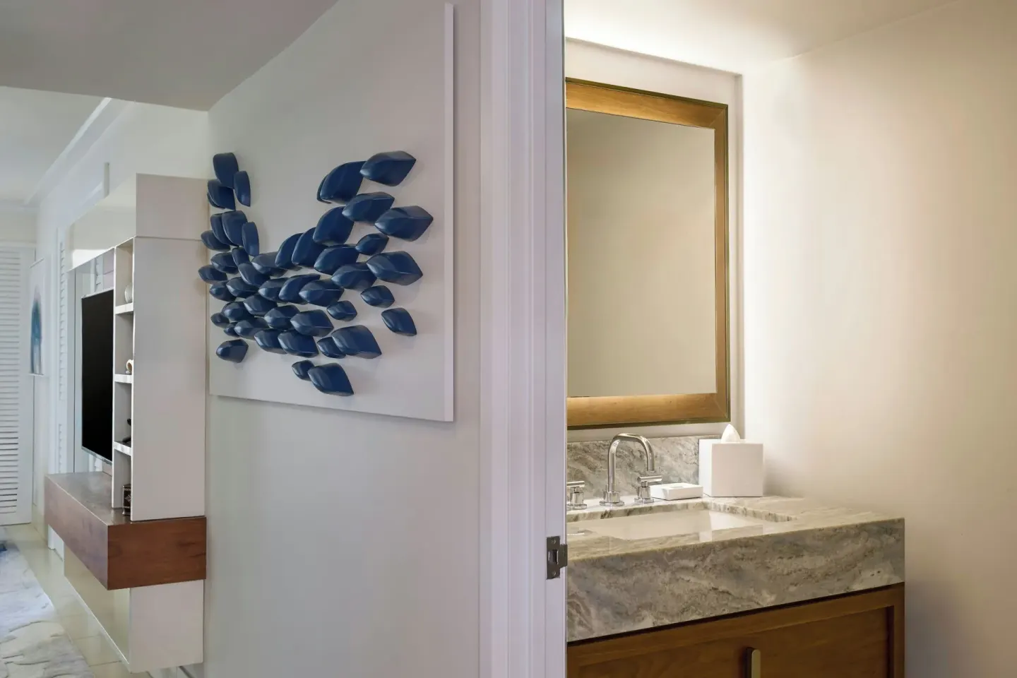 Suite entry and vanity at Wailea Beach Resort - Marriott, Maui with blue wall art and marble counter.