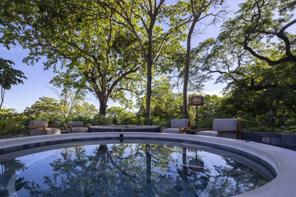 Circular plunge pool beneath trees at Waldorf Astoria Costa Rica Punta Cacique.