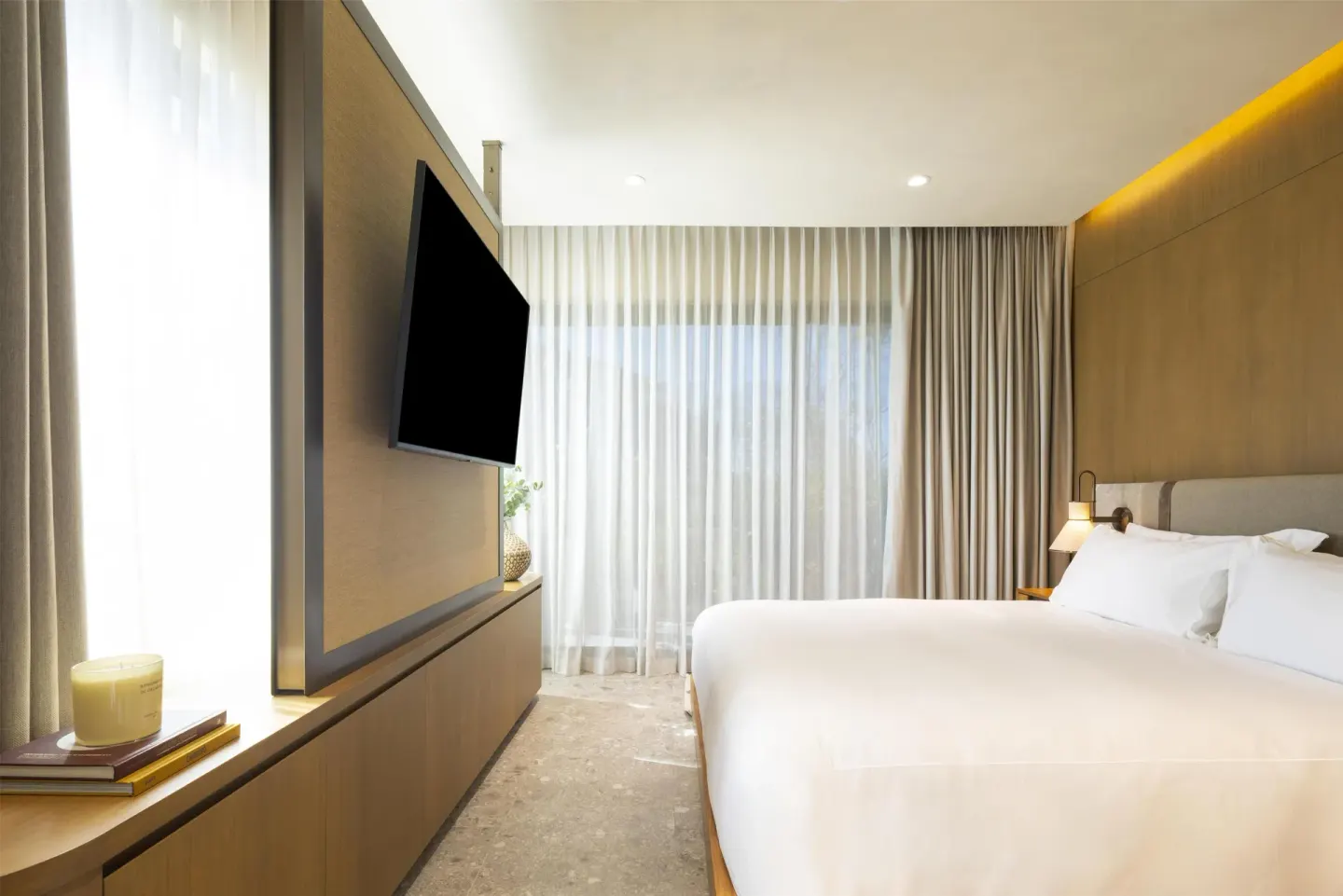 King guest room with TV wall and sheer curtains at Waldorf Astoria Costa Rica Punta Cacique.