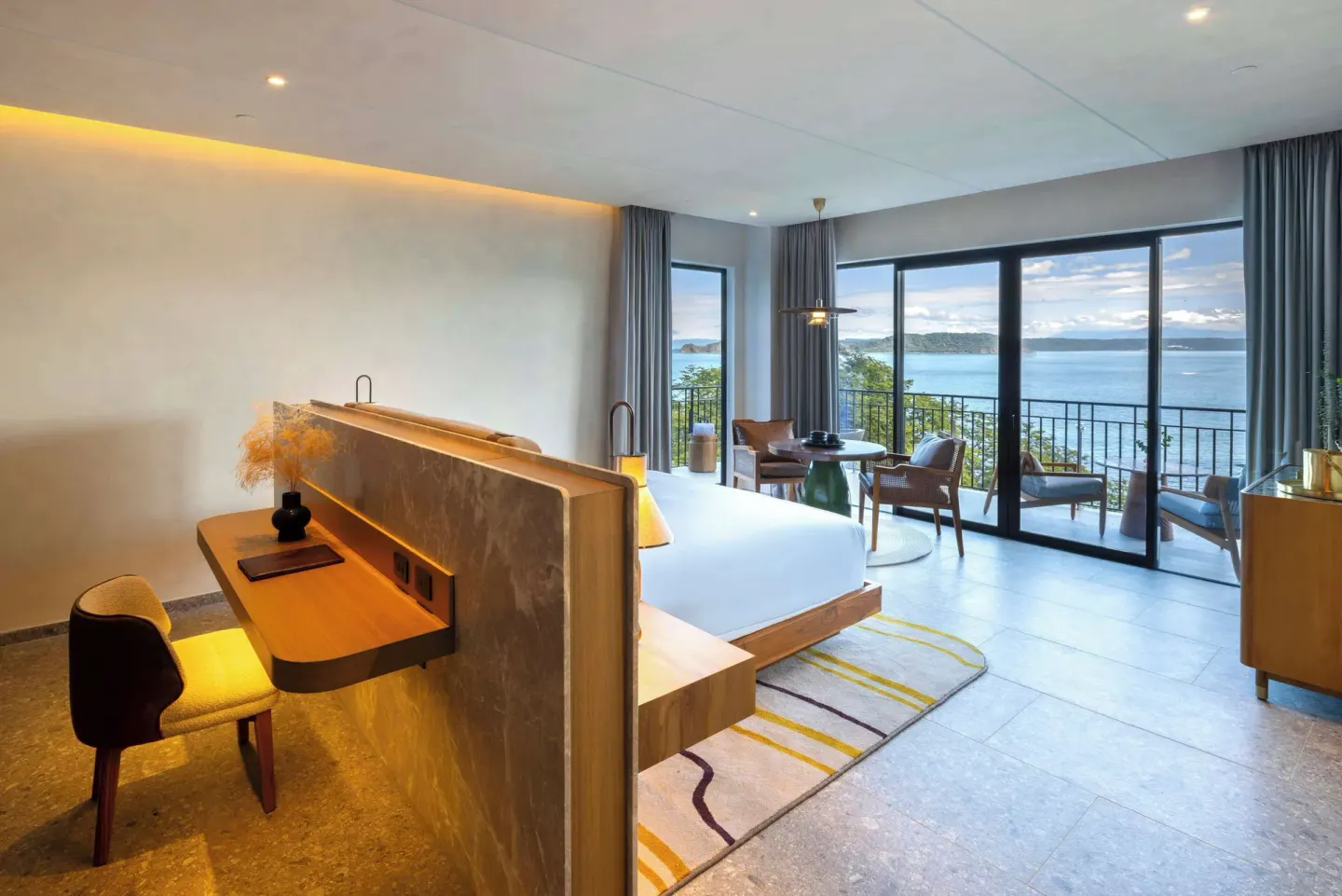 King bed guest room with ocean-view balcony at Waldorf Astoria Costa Rica Punta Cacique.