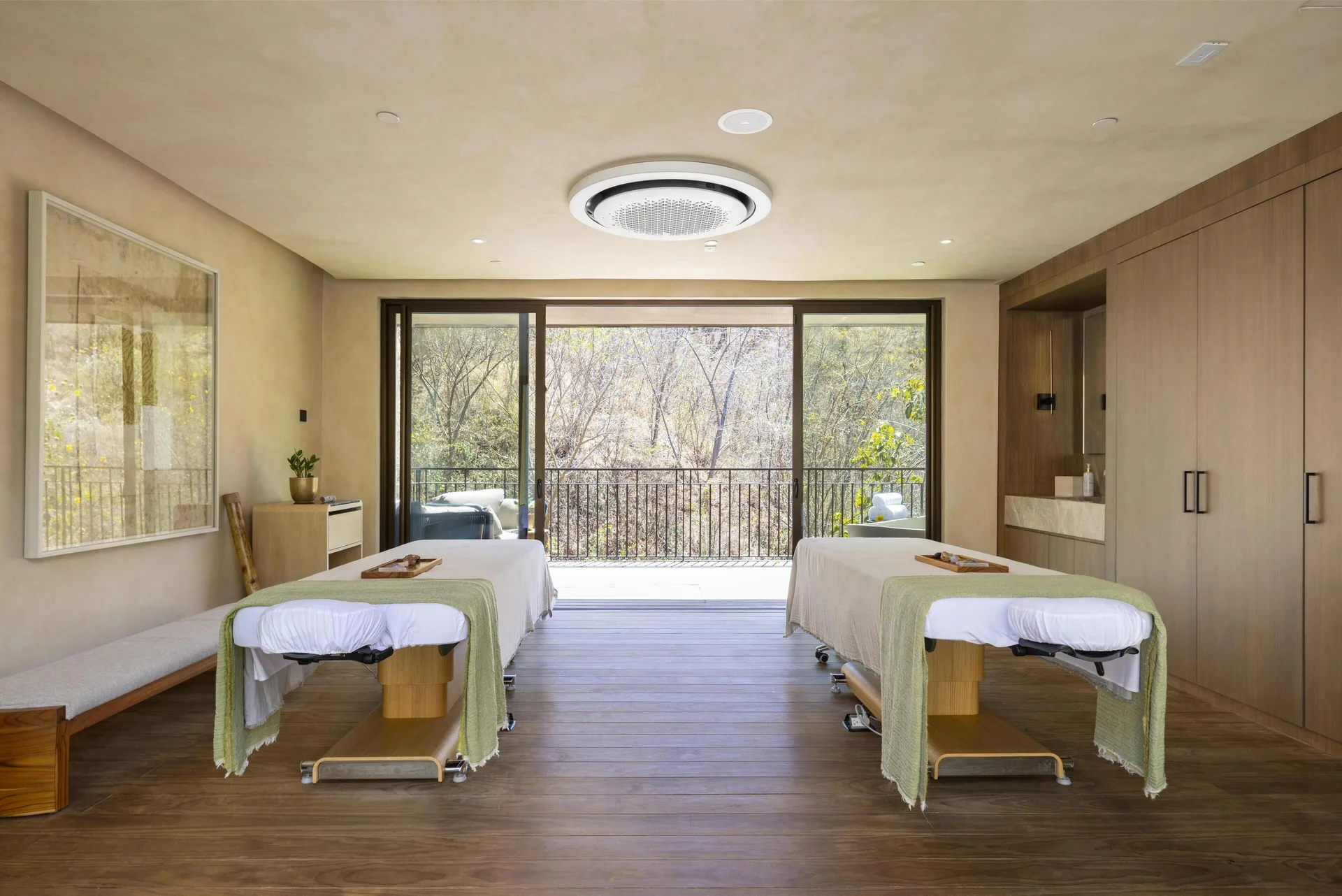 Spacious spa suite with two massage tables and balcony at Waldorf Astoria Costa Rica Punta Cacique.