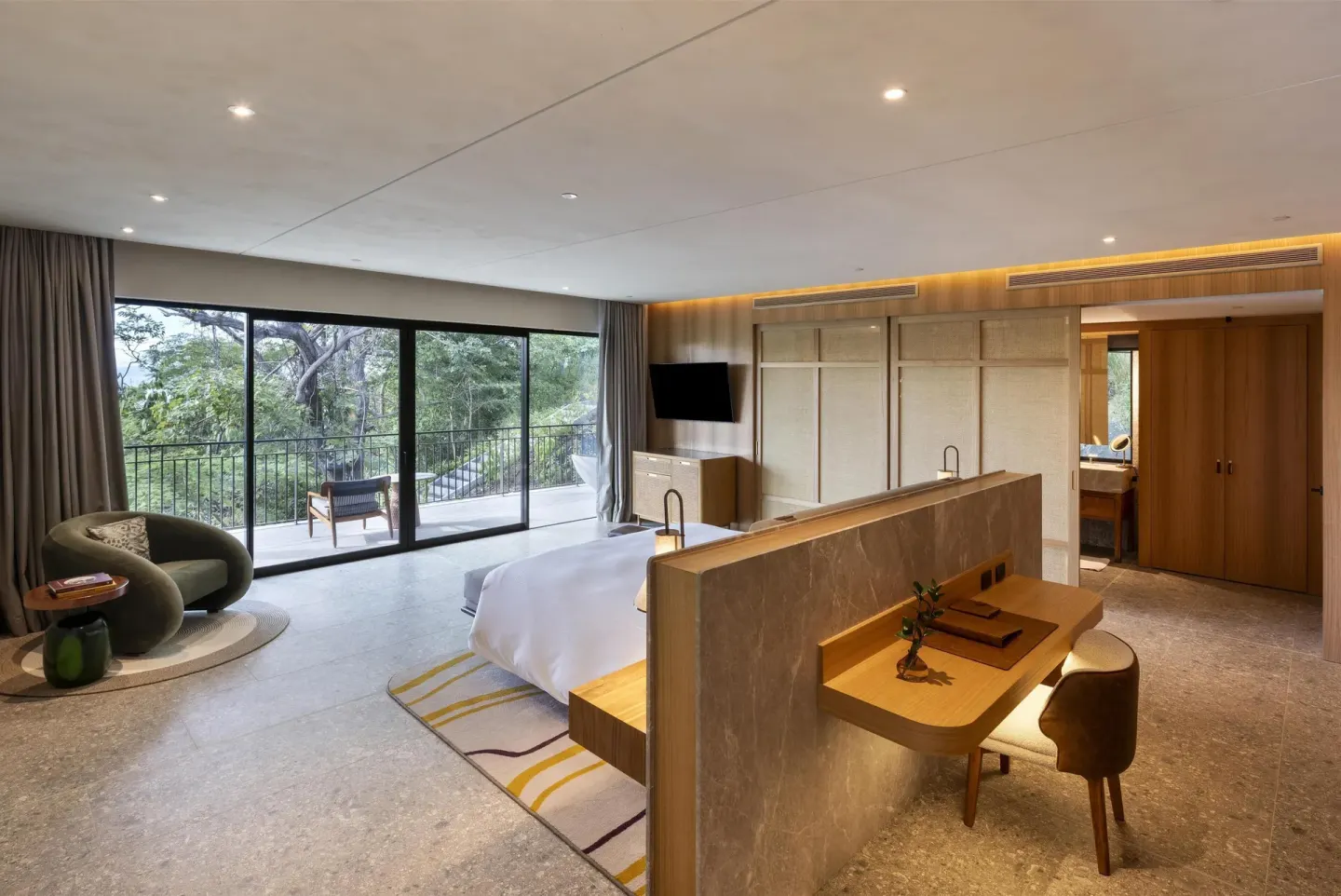 Spacious king suite with lounge seating and forest balcony at Waldorf Astoria Costa Rica Punta Cacique.