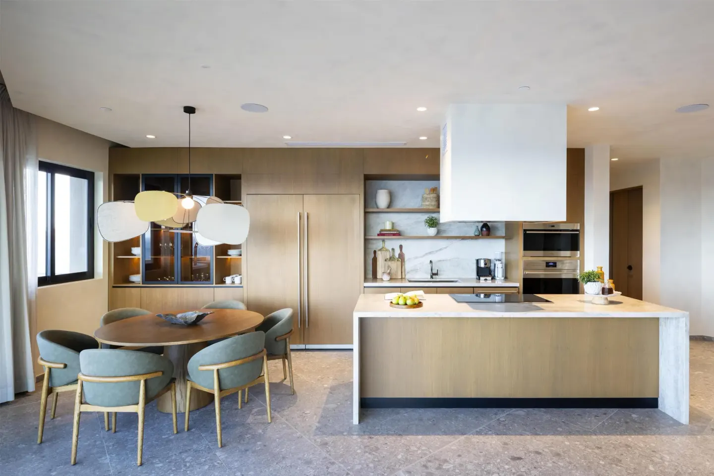 Suite kitchen and round dining table with pendant light at Waldorf Astoria Costa Rica Punta Cacique.