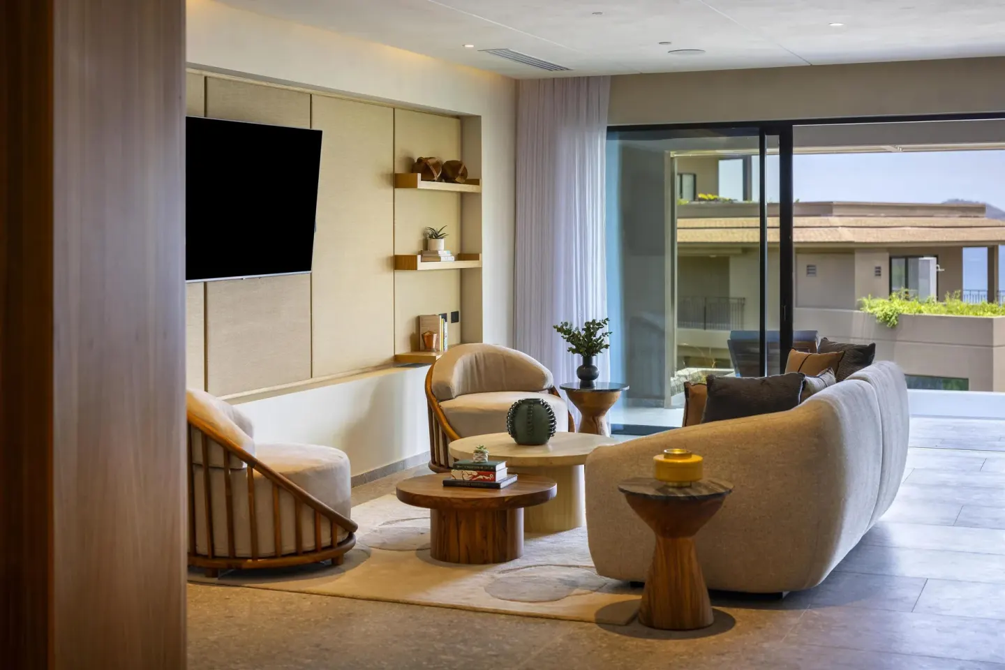 Suite lounge seating and balcony doors at Waldorf Astoria Costa Rica Punta Cacique.