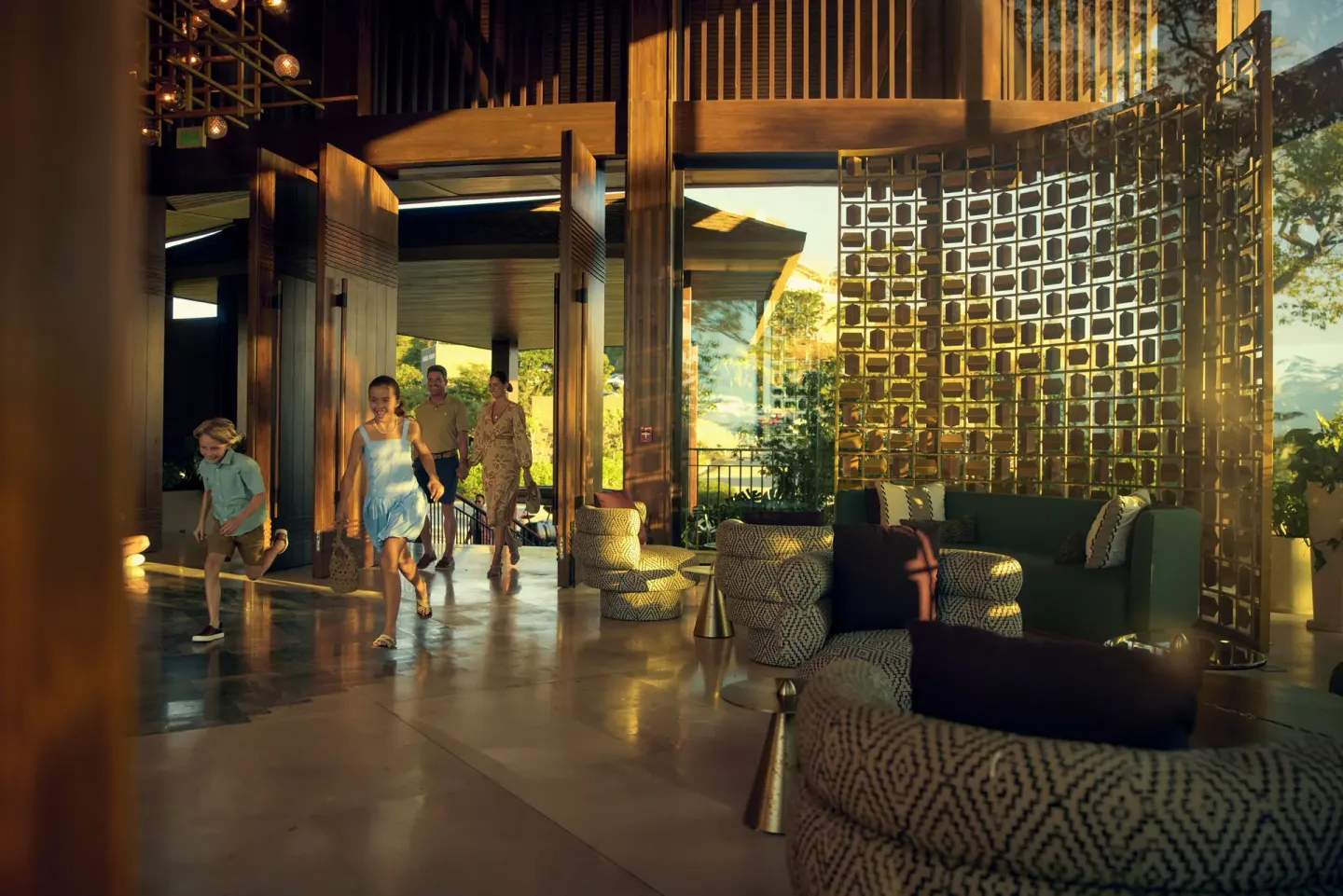 Guests entering the sunlit lobby of Waldorf Astoria Costa Rica Punta Cacique beside lounge seating.