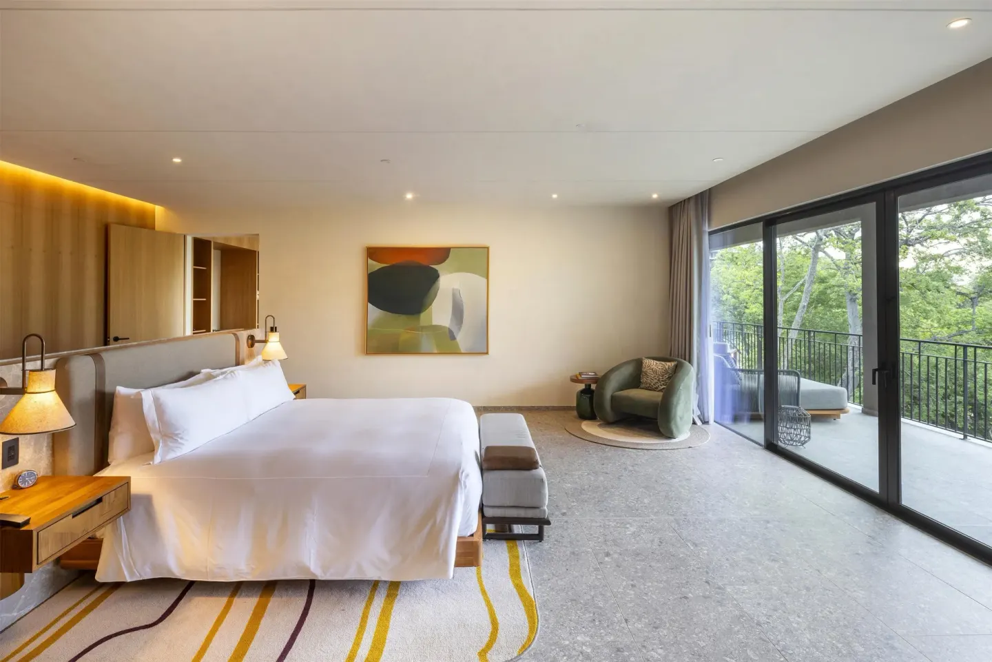 King guest room with terrace and trees outside at Waldorf Astoria Costa Rica Punta Cacique.