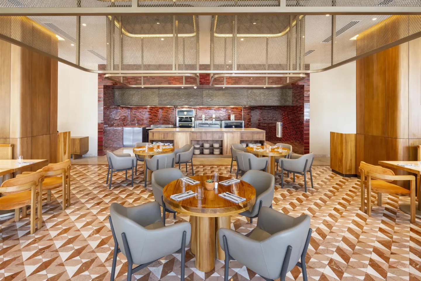 Restaurant tables facing an open kitchen at Waldorf Astoria Costa Rica Punta Cacique.