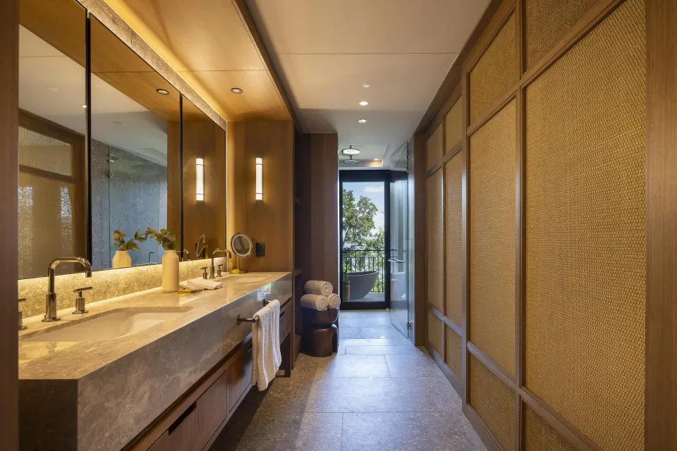 Bathroom vanity and terrace view in the Bahia View 1 Bedroom Suite at Waldorf Astoria Costa Rica Punta Cacique.
