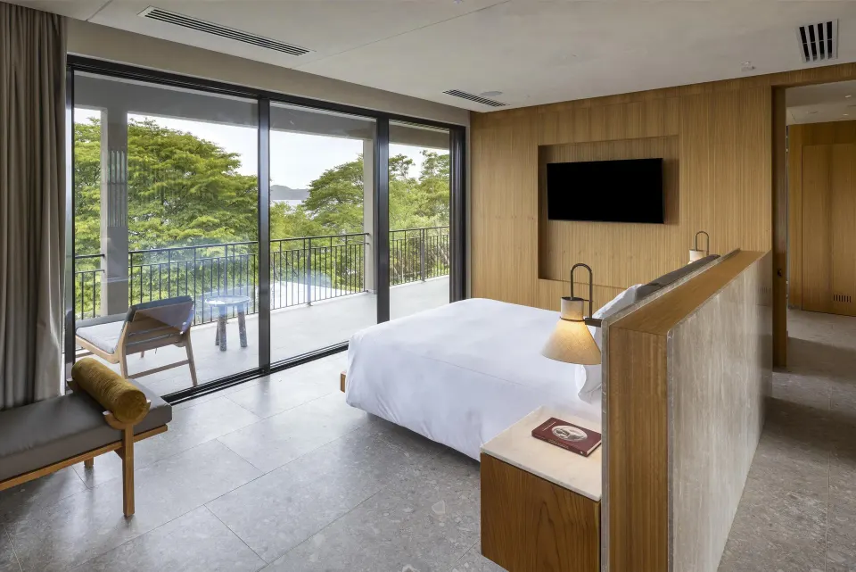 Bahia View 1 Room king bed with balcony and bay glimpse at Waldorf Astoria Costa Rica Punta Cacique.