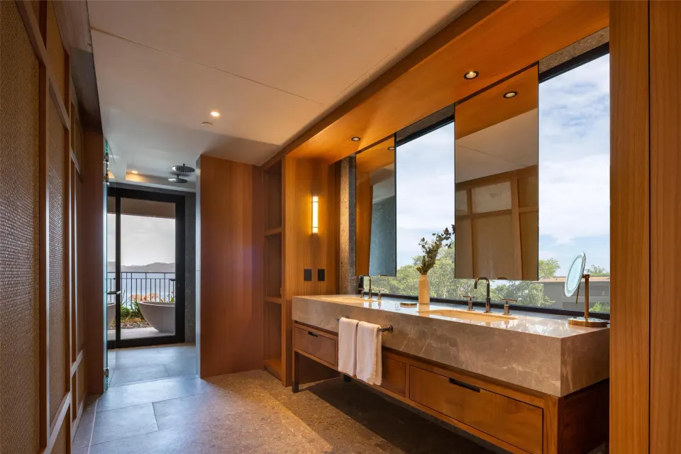 Bathroom vanity and terrace tub in a Bahia View room at Waldorf Astoria Costa Rica Punta Cacique.