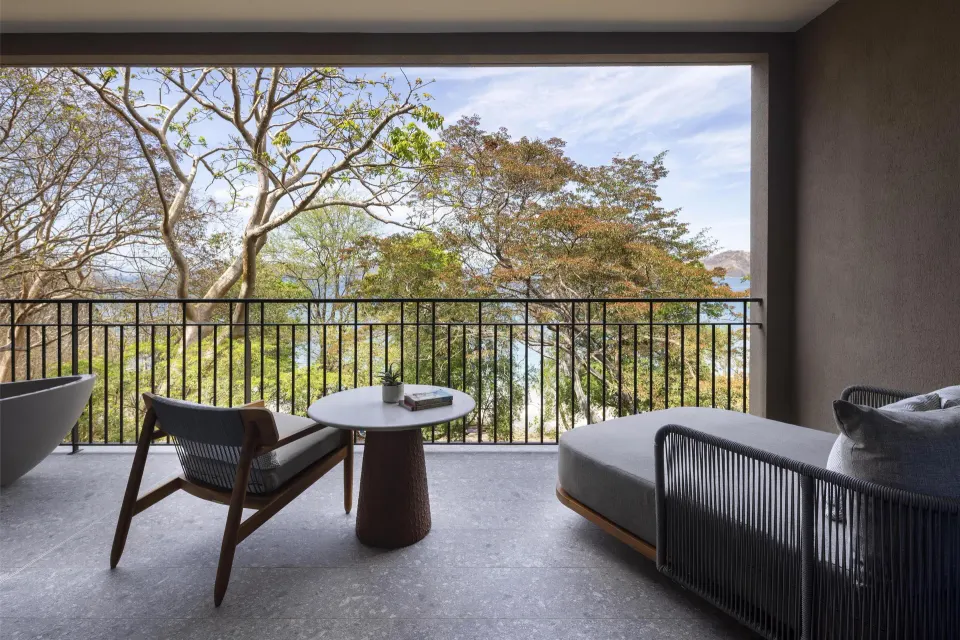Bahia View balcony with lounge seating and bay glimpses at Waldorf Astoria Costa Rica Punta Cacique.