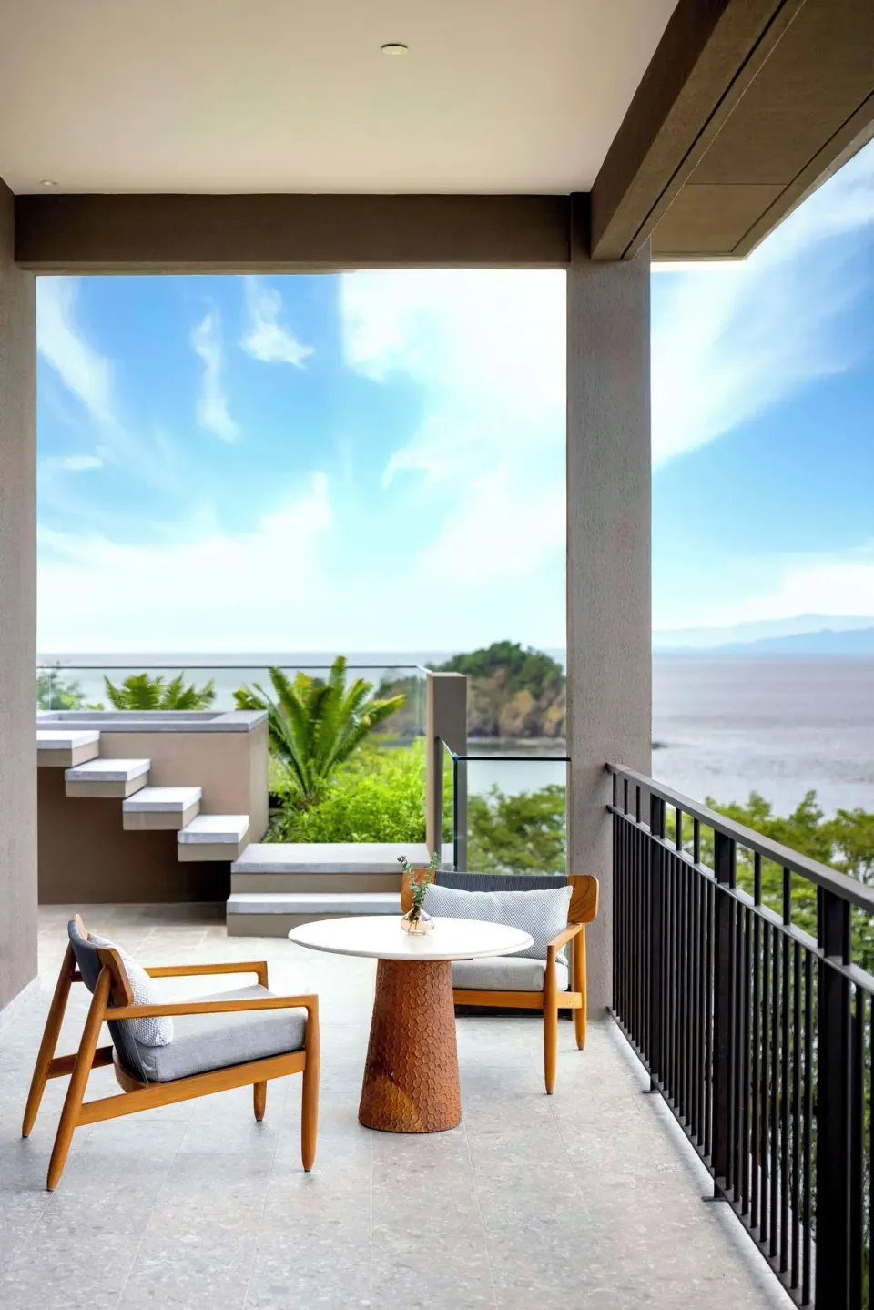 Covered balcony seating with ocean view at Waldorf Astoria Costa Rica Punta Cacique.