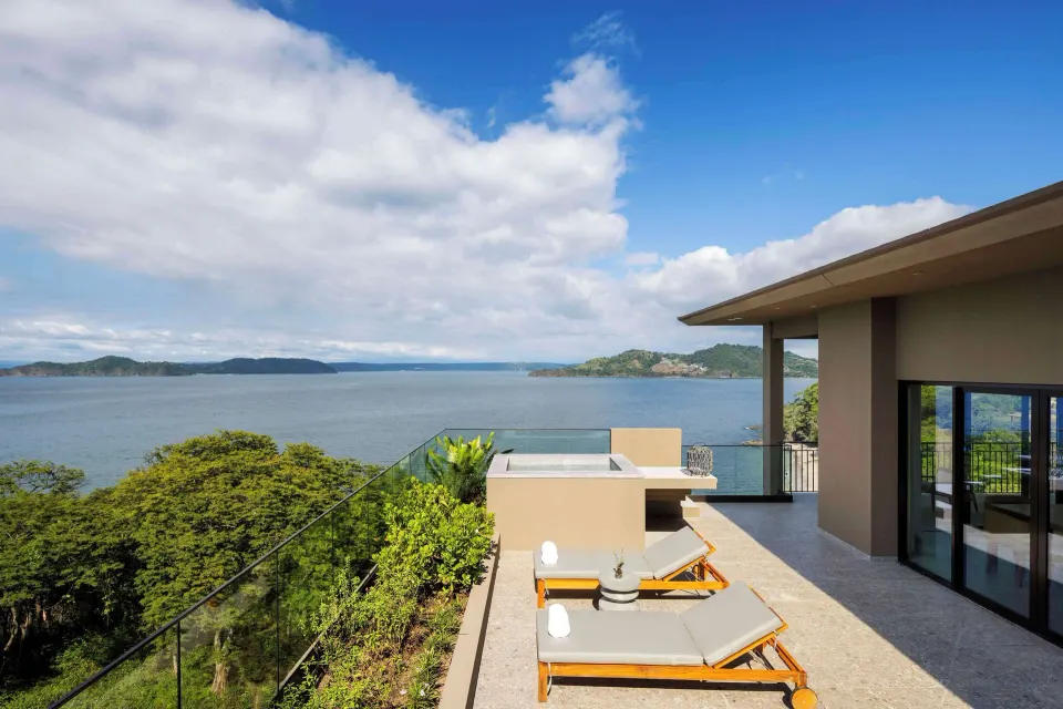 Oceanfront suite terrace with loungers at Waldorf Astoria Costa Rica Punta Cacique.