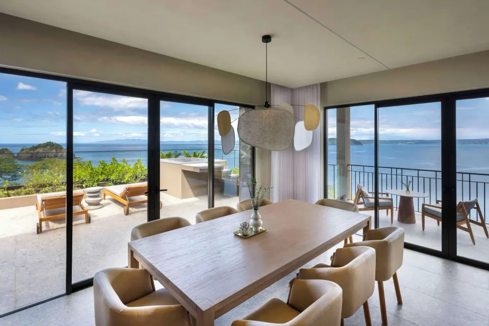 Dining area and ocean terrace in an Ocean 1 One Bedroom Suite at Waldorf Astoria Costa Rica Punta Cacique.
