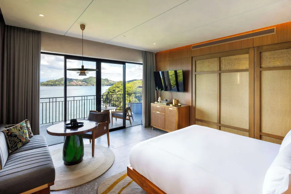 King bed and sitting area with balcony ocean view at Waldorf Astoria Costa Rica Punta Cacique.