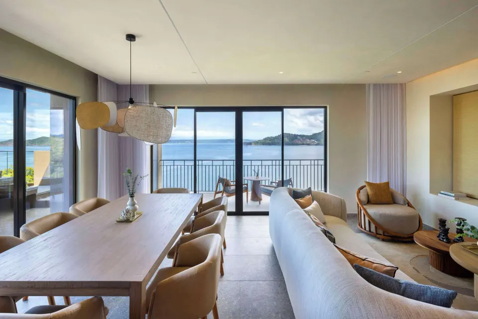 Living and dining area with balcony ocean views at Waldorf Astoria Costa Rica Punta Cacique.