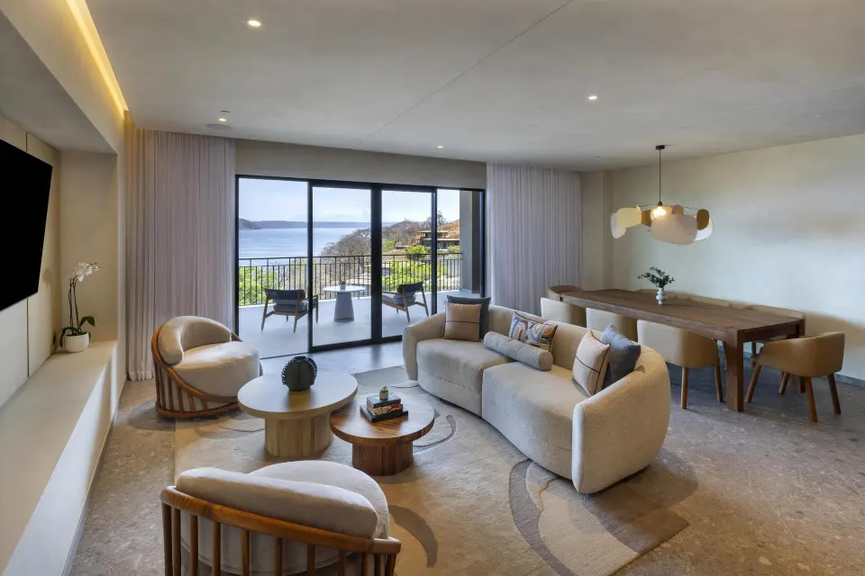 Ocean View 1 Bedroom Suite living room with dining table and balcony at Waldorf Astoria Costa Rica Punta Cacique.