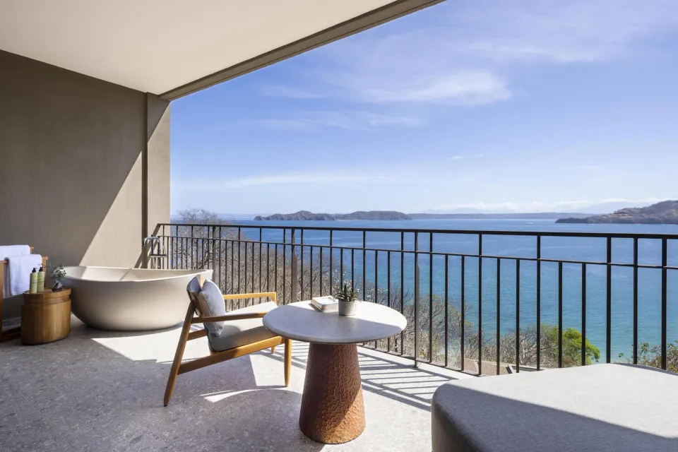 Ocean View 1 Room terrace with soaking tub, chair, table, and ocean view at Waldorf Astoria Costa Rica Punta Cacique.