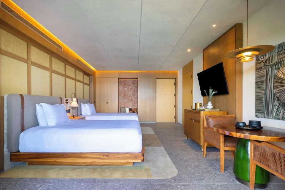 Ocean View 2 Queens Room with two queen beds and wood furnishings at Waldorf Astoria Costa Rica Punta Cacique.